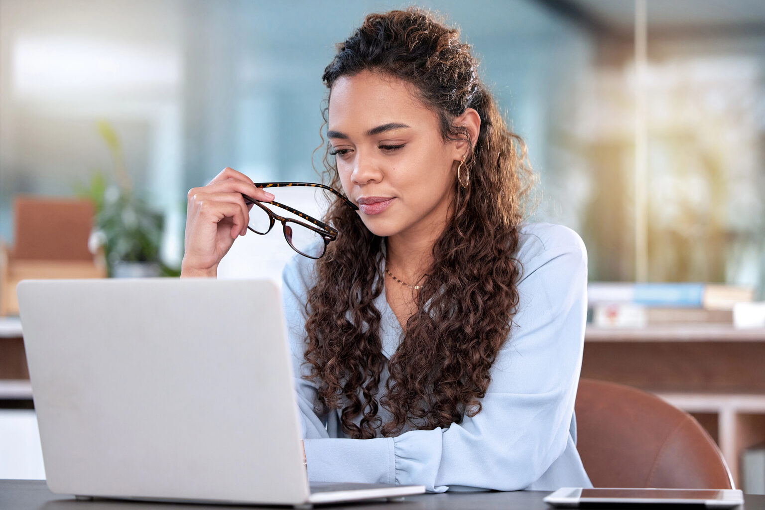Business owner reviewing her books on a laptop