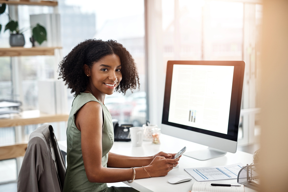 Smiling small business owner reviewing finances